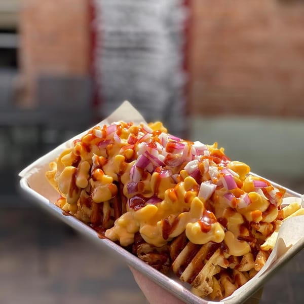 Lindy's on 4th's waffle fries topped with mac and cheese, BBQ sauce, and red onions.