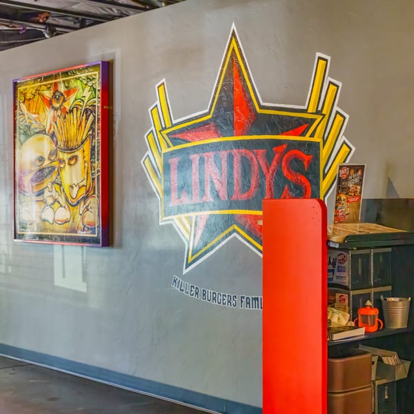 Lindy's on 4th restaurant interior with a large star logo and a quirky burger art piece.