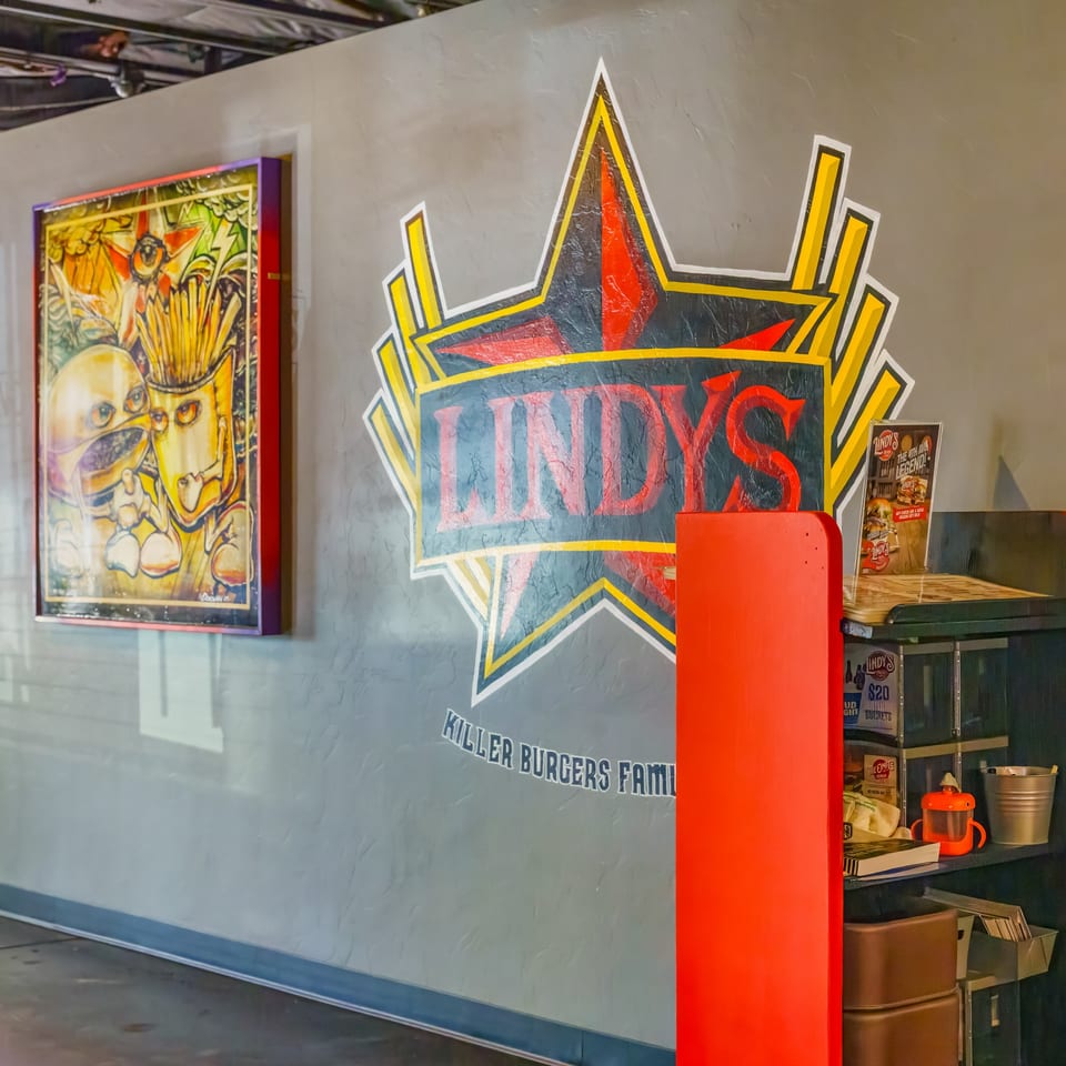 Lindy's on 4th restaurant interior with a large star logo and a quirky burger art piece.